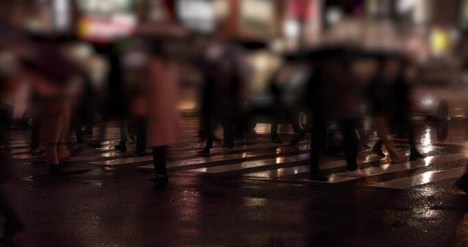 A high speed shooting of walking people body parts at Shibuya crossing rainy day