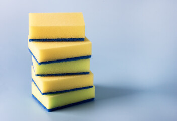 Yellow Sponges for Dishwashing on Blue Background Horizontal Copy Space