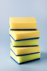 Yellow Sponges for Dishwashing on Blue Background Vertical