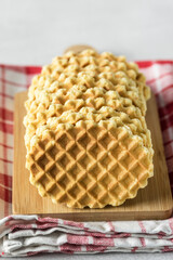Tasty Homemade Waffles on wooden Tray Napkin Close up Vertical