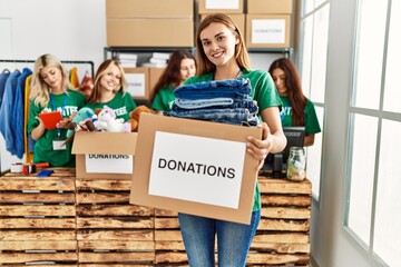 Group of young volunteers woman smiling happy working at charity center.