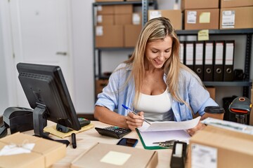 Fototapeta na wymiar Young blonde woman ecommerce business worker working at office