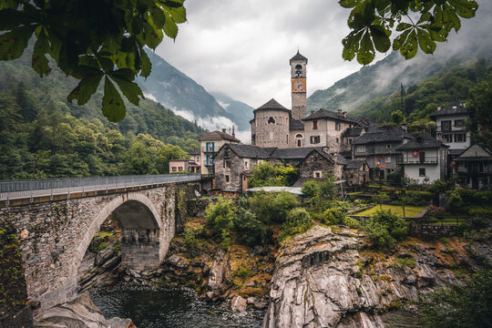 View on the Lavertezzo village, famous tourist destination - An old Swiss village with double arch stone bridge at Ponte dei Salti with waterfall, Lavertezzo, Verzascatal, Canton Tessin