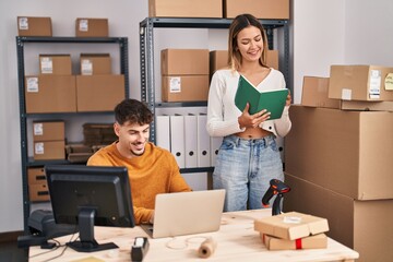 Young man and woman ecommerce business workers working at office