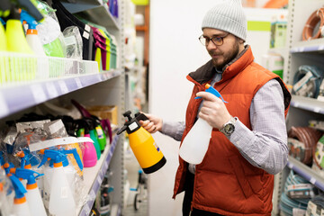 the buyer in the store chooses a spray bottle