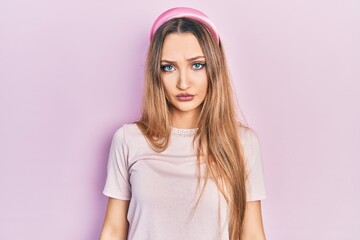 Obraz premium Young blonde girl wearing casual clothes depressed and worry for distress, crying angry and afraid. sad expression.
