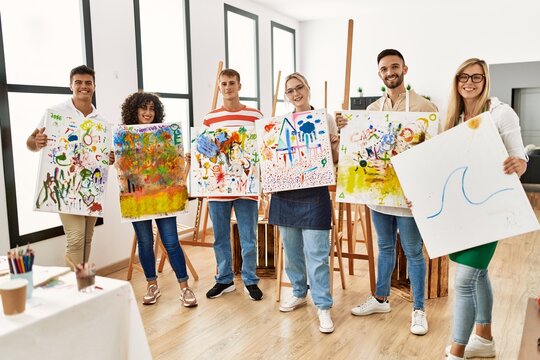 Group of people smiling happy canvas with draw standing at art studio.