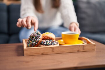 Young woman having breakfast at home