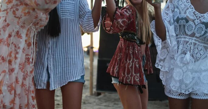 Multiracial female friends having fun dancing together outdoor at beach party 