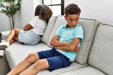 Brother and sister angry having problem sitting on sofa at home