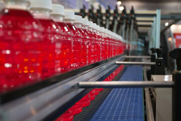 Red Soft Drink transfer on Conveyor Belt System.
