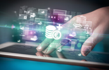 Close-up of a hand using tablet, currency concept