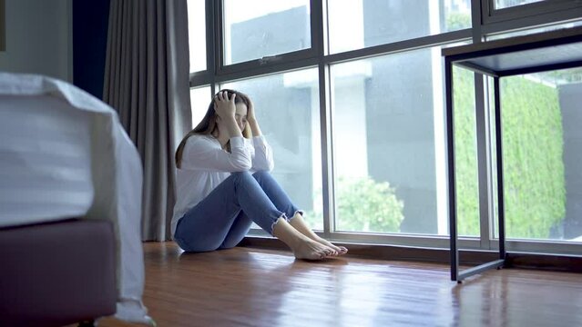 Depressed woman sitting alone with cuddle herself and Loneliness sad female think grief trouble life problem. family problems, Stress,  The concept of depression and mental health concept. 