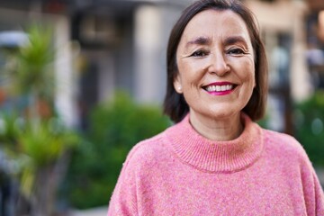Middle age woman smiling confident standing at park