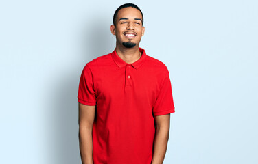 Young african american man wearing casual polo with a happy and cool smile on face. lucky person.