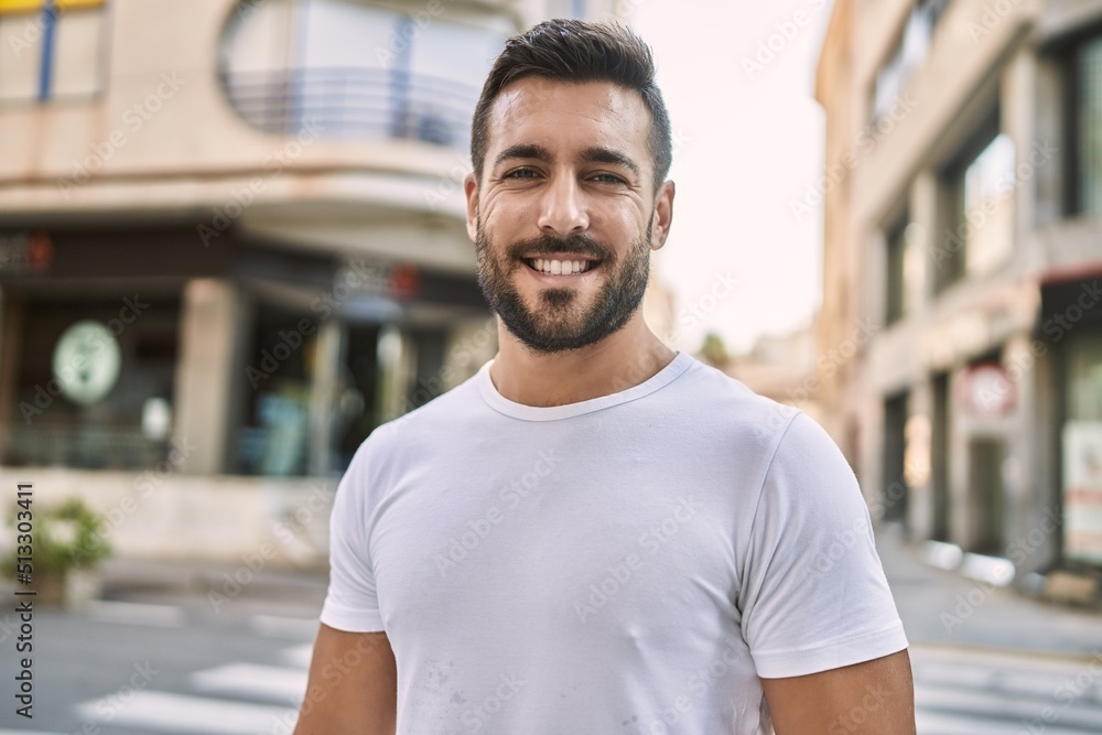 Poster Young hispanic man smiling confident walking at street