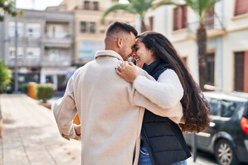 Fototapeta premium Man and woman smiling confident dancing at street
