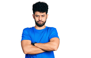 Young arab man with beard wearing casual blue t shirt skeptic and nervous, disapproving expression...