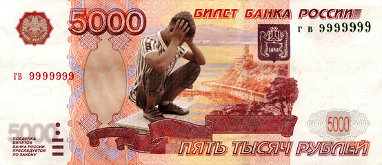 Background, 5 thousand rubles of Russia, A man sitting in a desperate situation. A symbol of the financial crisis in Russia.