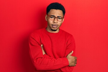 Young african american man wearing casual clothes and glasses skeptic and nervous, disapproving expression on face with crossed arms. negative person.