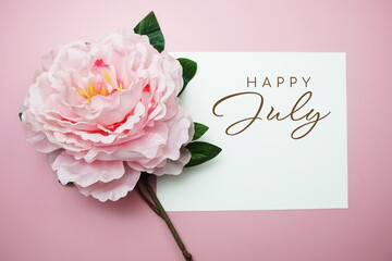 Happy July typography text with flowers on pink background