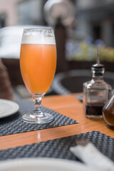 light beer in a glass on a table in a bar. Street cafe on a summer day.