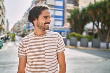 Young hispanic man smiling confident at street