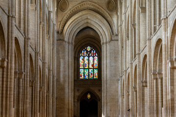Fototapeta premium the central nave of the Ely Cathedral with its historic stained glass window