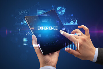 Businessman holding a foldable smartphone, business concept