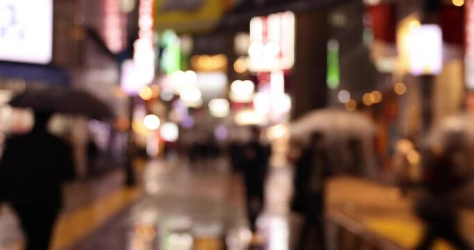 A high speed shooting of defocused walking people at Shibuya crossing rainy day