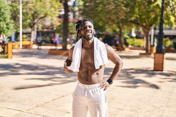 African american woman shirtless smiling confident standing at park