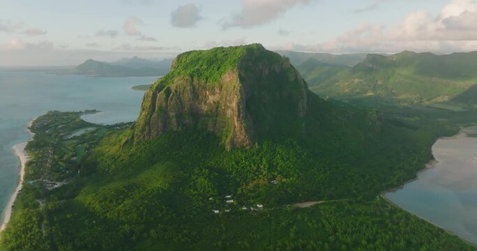 Aerial view. Scenic landscape wild nature tropical island with rocky mountains overgrown dense green jungle tree, palm. Modern and ecologic green spaces with many trees. Green palms and other plants
