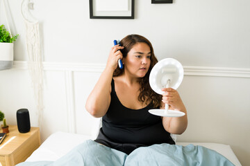 Plus size woman brushing her hair before sleep