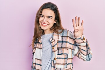 Young caucasian girl wearing casual clothes showing and pointing up with fingers number four while smiling confident and happy.