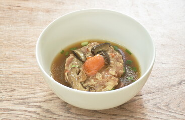steamed chop pork topping salty egg yolk with mushroom in gravy sauce on bowl