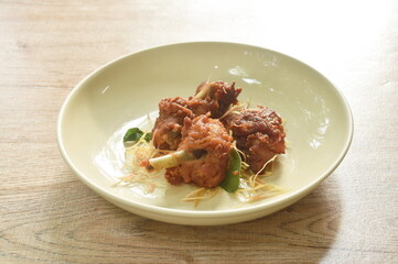 spicy fried chicken with chili and slice lemon grass on dish