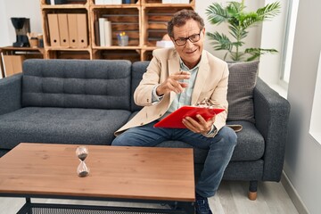 Fototapeta premium Middle age man having psychology session at clinic