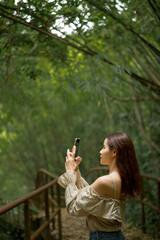 asian woman with a camera in a park, asian woman with a camera in forest