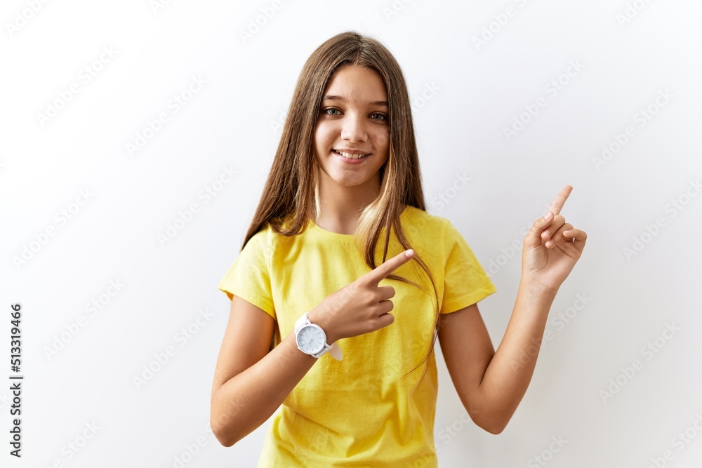 Sticker Young brunette teenager standing together over isolated background smiling and looking at the camera pointing with two hands and fingers to the side.