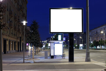 Fototapeta premium Large horizontal billboard in the night city. Expanse of the night city. Mock-up.