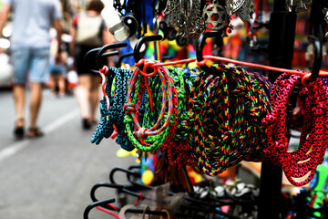Market stall, photo of handmade bracelets of different colors, at the Fogueras festivities in...