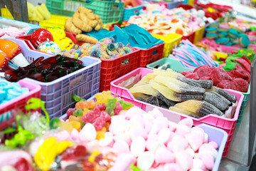 Sweet and colorful candy stall at a flea market in Alicante's fogueres festivities.