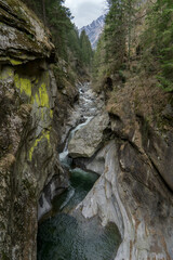 canyon of passeier surrounded by mountains with rocks and trees 