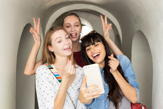 group of happy women friends taking selfie photo together