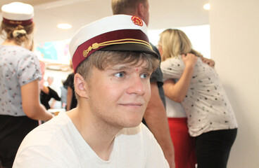 Young happy Danish male student with a student cap at graduation
