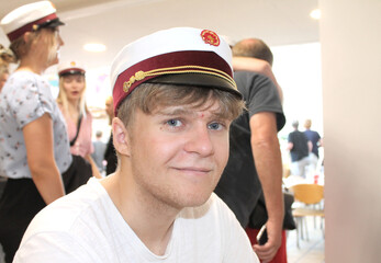 Young happy Danish male student with a student cap at graduation