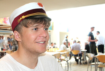 Young happy Danish male student with a student cap at graduation - obrazy, fototapety, plakaty