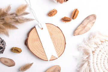 Rectangle strip white tag mockup on a white background with cotton string and boho decoration, dry plants, element for packing. Label product bohemian mockup copy space for text and natural eco design © Anna Fedorova