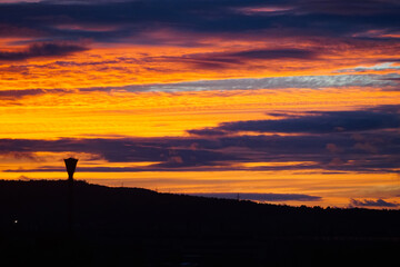incredible fiery sunset, orange pink evening sky over earth, hills, mountains, hills and water tower, contrast dark photo, beautiful nature wallpaper, background