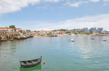 Cascais near Lisbon, seaside town. Panoramic view of the coastline, picturesque rocks and boats in a summer sunny day. Portugal